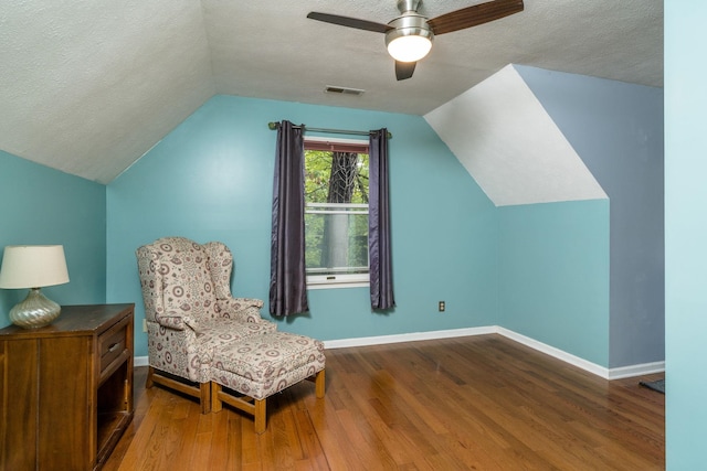 sitting room featuring vaulted ceiling, ceiling fan, hardwood / wood-style floors, and a textured ceiling