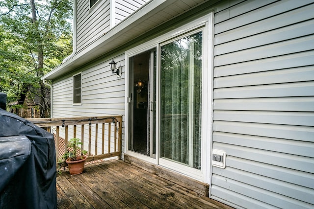 view of exterior entry featuring a wooden deck