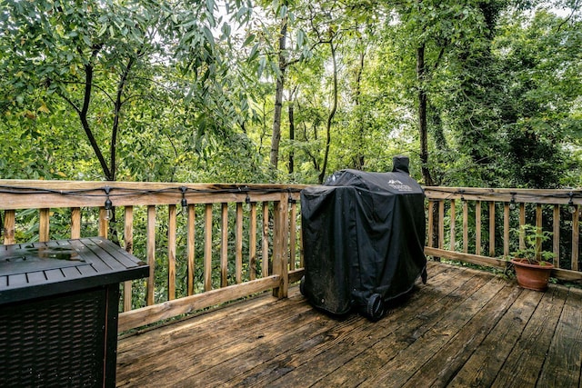 wooden deck featuring a grill