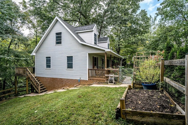 back of house with a lawn