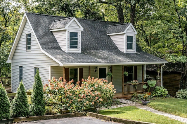 cape cod-style house featuring covered porch