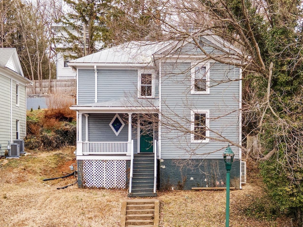 rear view of property featuring a porch