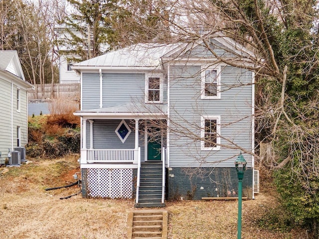 rear view of property featuring a porch