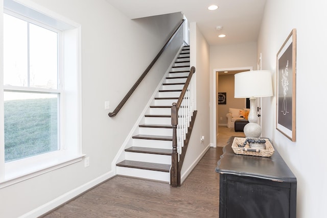 stairs featuring a wealth of natural light, baseboards, and wood finished floors