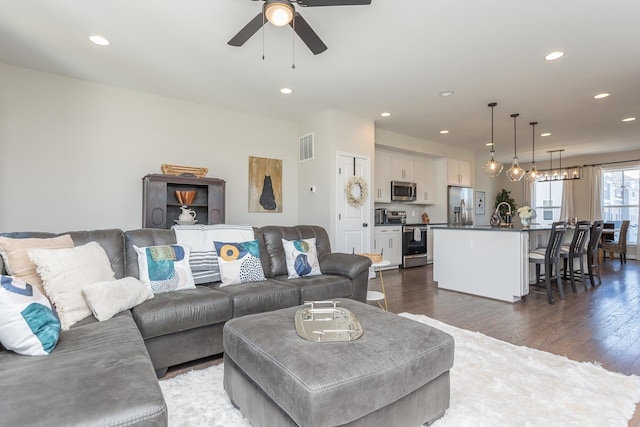 living room featuring recessed lighting, dark wood-style floors, visible vents, and ceiling fan