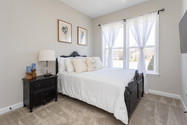 bedroom featuring baseboards and light carpet