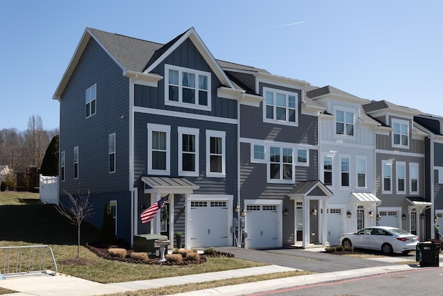 multi unit property featuring driveway, an attached garage, board and batten siding, and a residential view