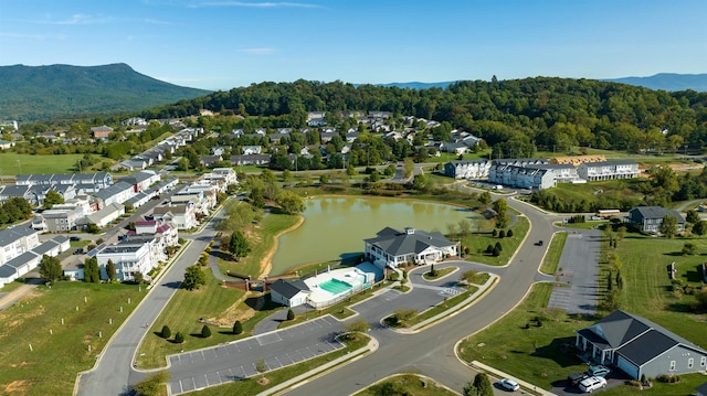 birds eye view of property with a water and mountain view