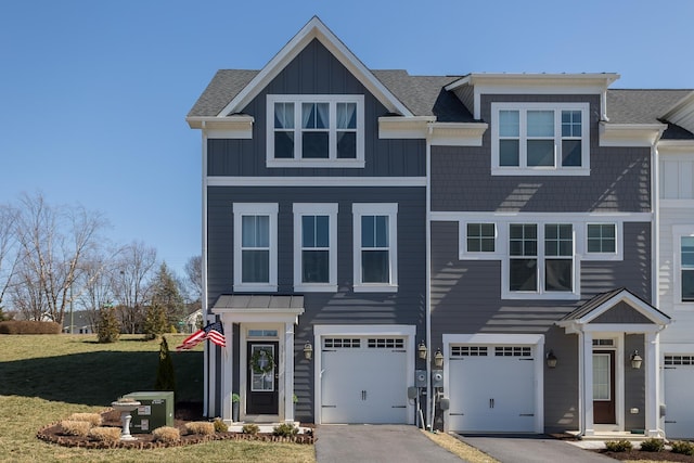 view of front of house with board and batten siding, a garage, driveway, and a shingled roof