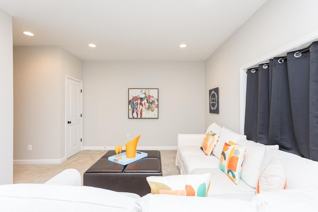 living area featuring recessed lighting, light colored carpet, and baseboards