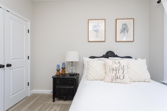 bedroom with baseboards and carpet floors