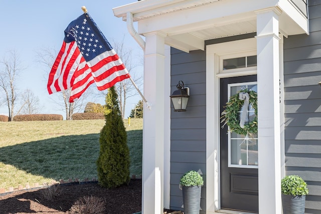 entrance to property featuring a yard