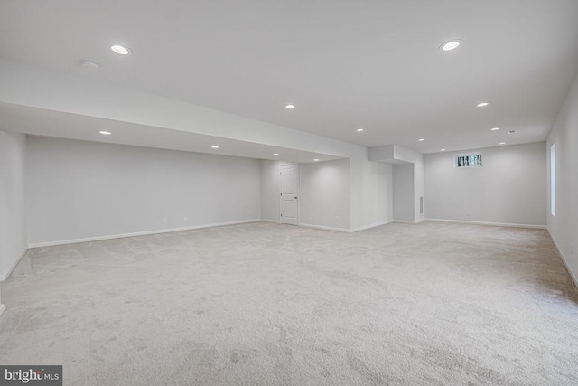 finished below grade area with recessed lighting, visible vents, and light colored carpet