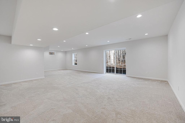 interior space featuring light carpet, baseboards, visible vents, and recessed lighting