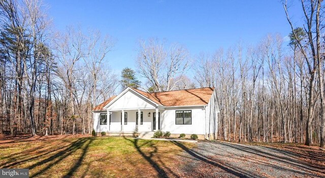 view of front of house with a porch and a front yard