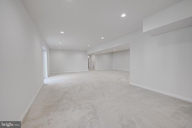 finished below grade area with recessed lighting, light colored carpet, and baseboards