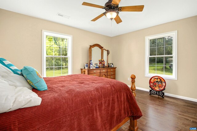 bedroom with ceiling fan and dark hardwood / wood-style floors