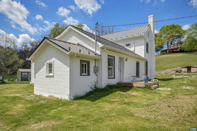 back of house with a lawn