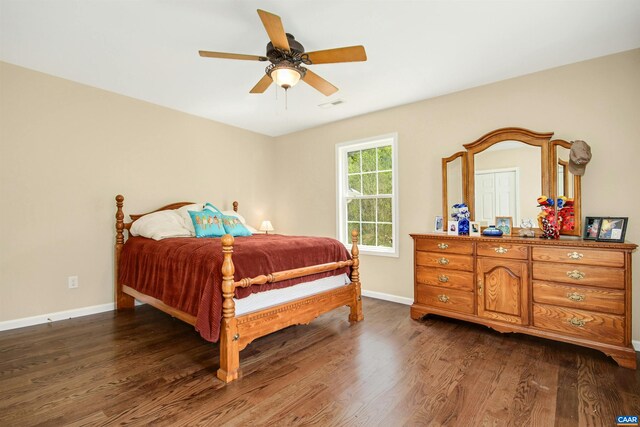 bedroom with dark wood-type flooring and ceiling fan