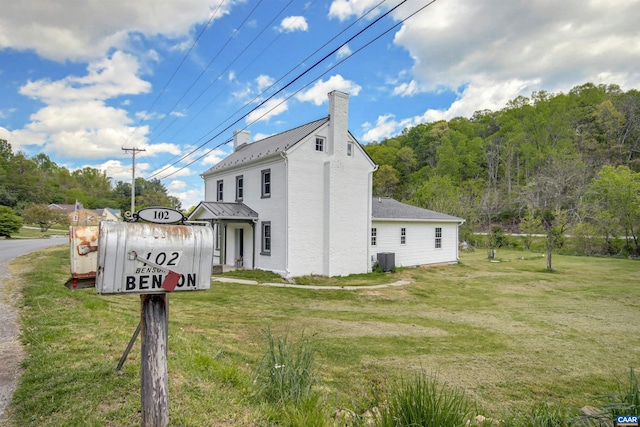 view of property exterior featuring a lawn