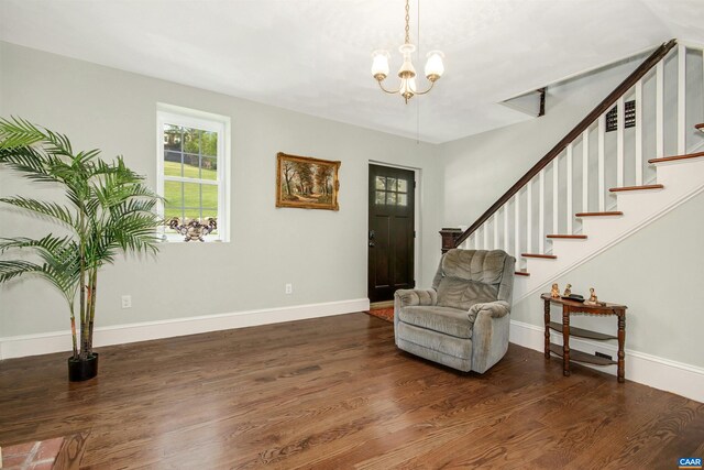 entrance foyer with dark wood-type flooring and a notable chandelier