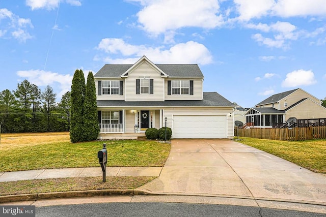 traditional-style home featuring a garage, concrete driveway, fence, a porch, and a front yard