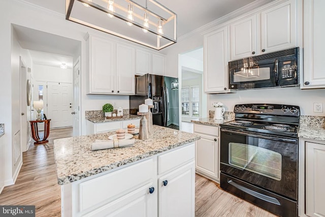 kitchen featuring white cabinets, light wood-style flooring, and black appliances