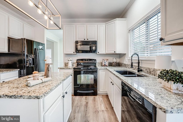 kitchen with light wood-style flooring, white cabinetry, a sink, light stone countertops, and black appliances