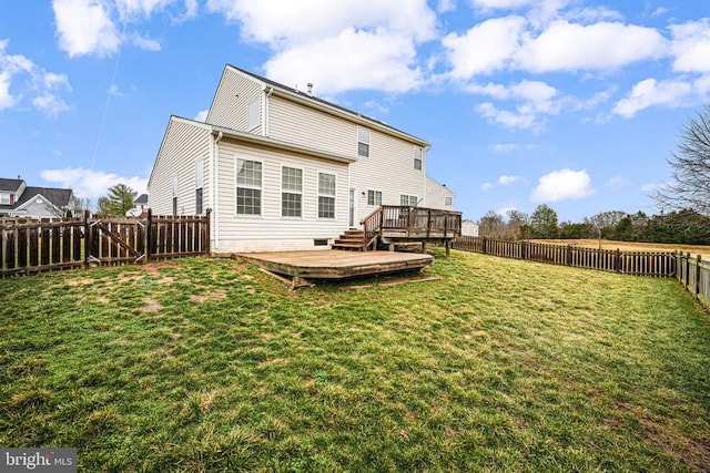 rear view of property with a fenced backyard, a lawn, and a wooden deck