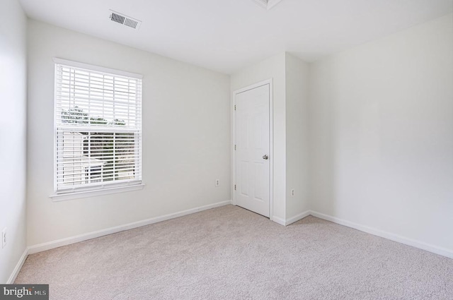 unfurnished bedroom featuring carpet floors, baseboards, and visible vents