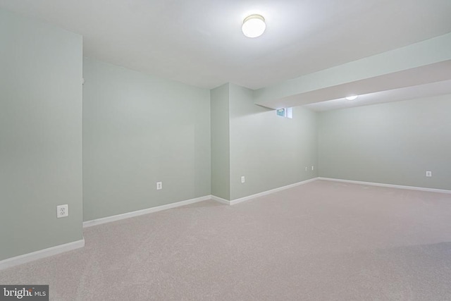 interior space with carpet flooring and baseboards