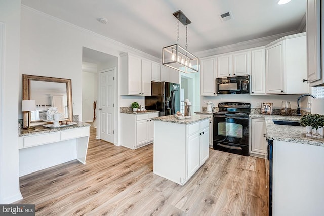 kitchen with black appliances, a sink, visible vents, and white cabinets