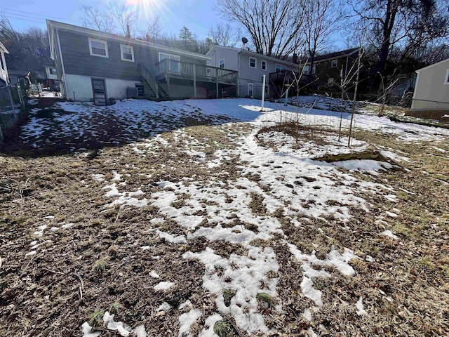 yard covered in snow featuring a wooden deck