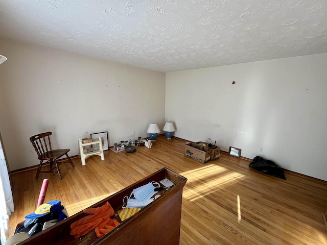 unfurnished living room with hardwood / wood-style floors and a textured ceiling