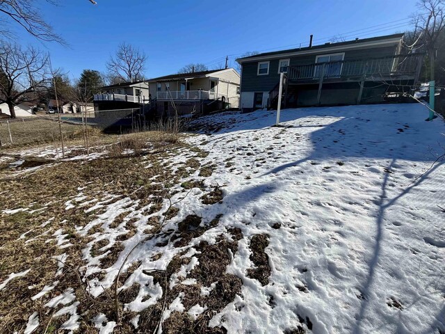 yard layered in snow featuring a wooden deck