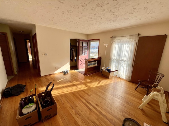 interior space featuring hardwood / wood-style flooring and a textured ceiling