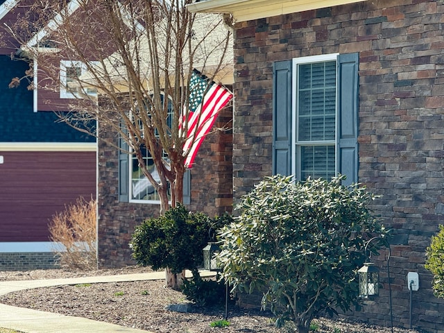 view of side of home with brick siding