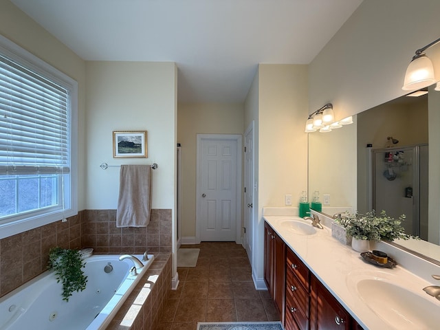 bathroom with a whirlpool tub, tile patterned flooring, a shower stall, and a sink