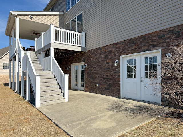 doorway to property with a deck, french doors, a patio area, and a ceiling fan