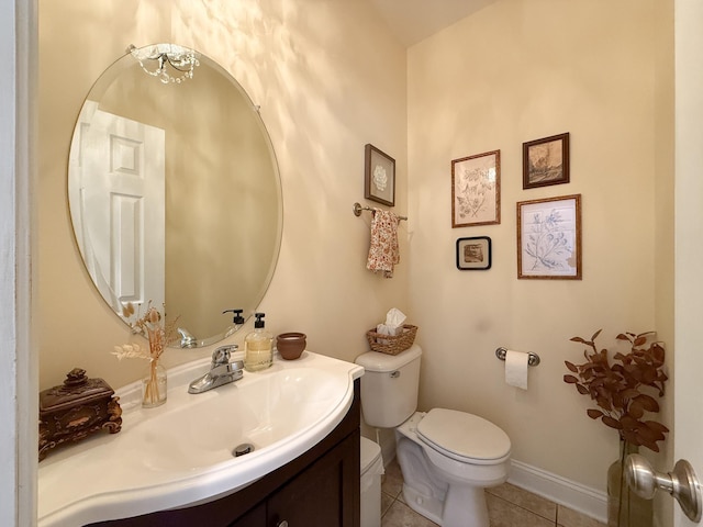 bathroom featuring tile patterned flooring, baseboards, vanity, and toilet