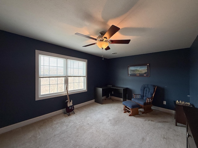 living area with baseboards, a textured ceiling, a ceiling fan, and carpet flooring