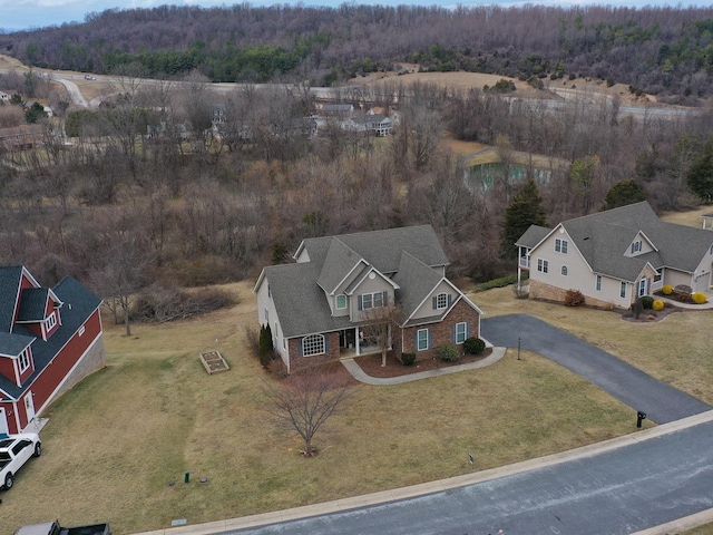 birds eye view of property with a view of trees