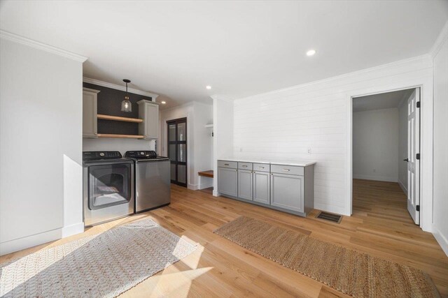 kitchen with separate washer and dryer, light wood-style floors, gray cabinets, open shelves, and decorative light fixtures