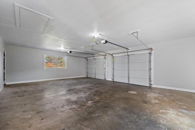 garage featuring a garage door opener and baseboards