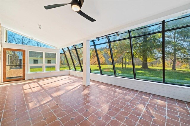 unfurnished sunroom with vaulted ceiling and ceiling fan