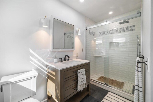 full bathroom featuring a stall shower, recessed lighting, and vanity