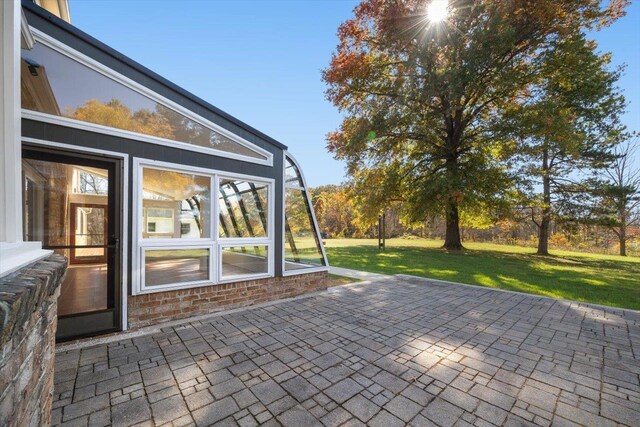 view of patio with a sunroom