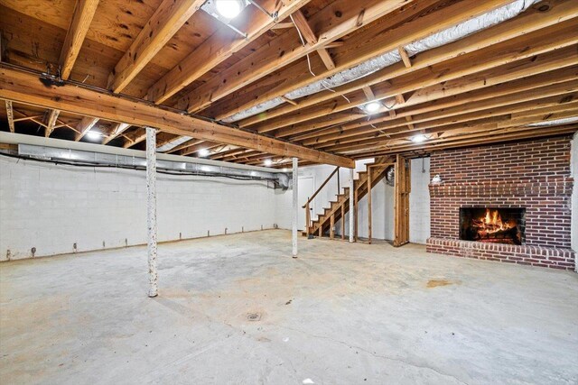 unfinished below grade area featuring a fireplace and stairway