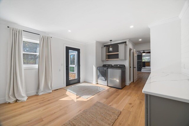 kitchen with washing machine and dryer, gray cabinets, plenty of natural light, and light wood-style flooring