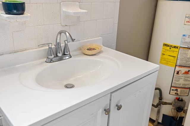 room details featuring gas water heater, vanity, and concrete block wall